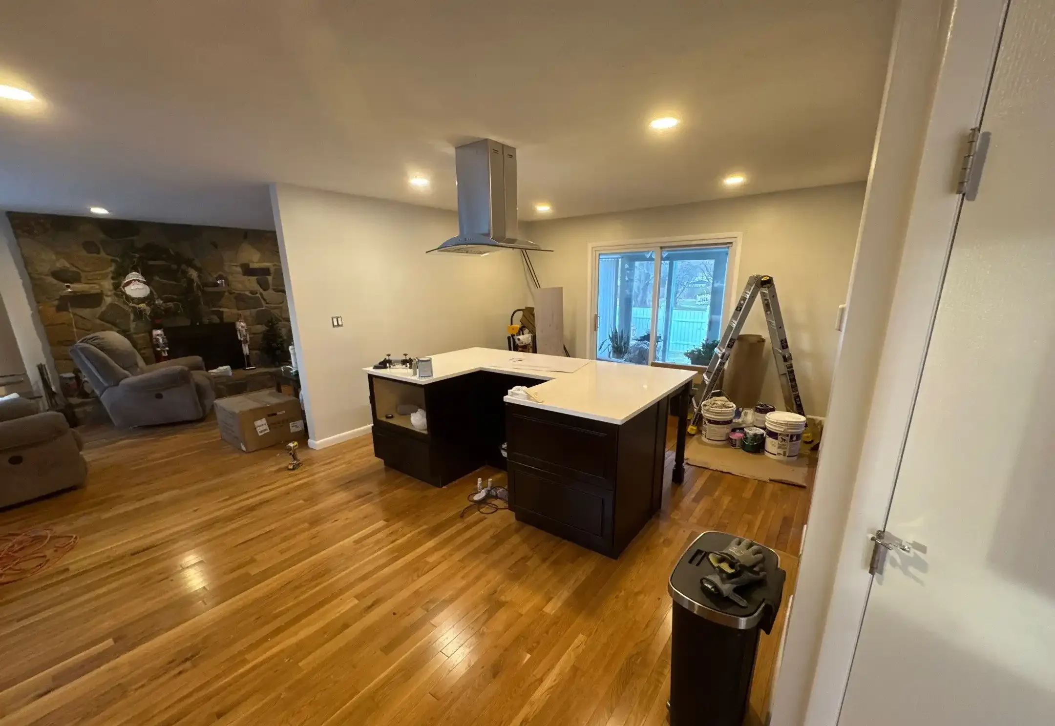 Kitchen remodeling with white cabinets and dark island